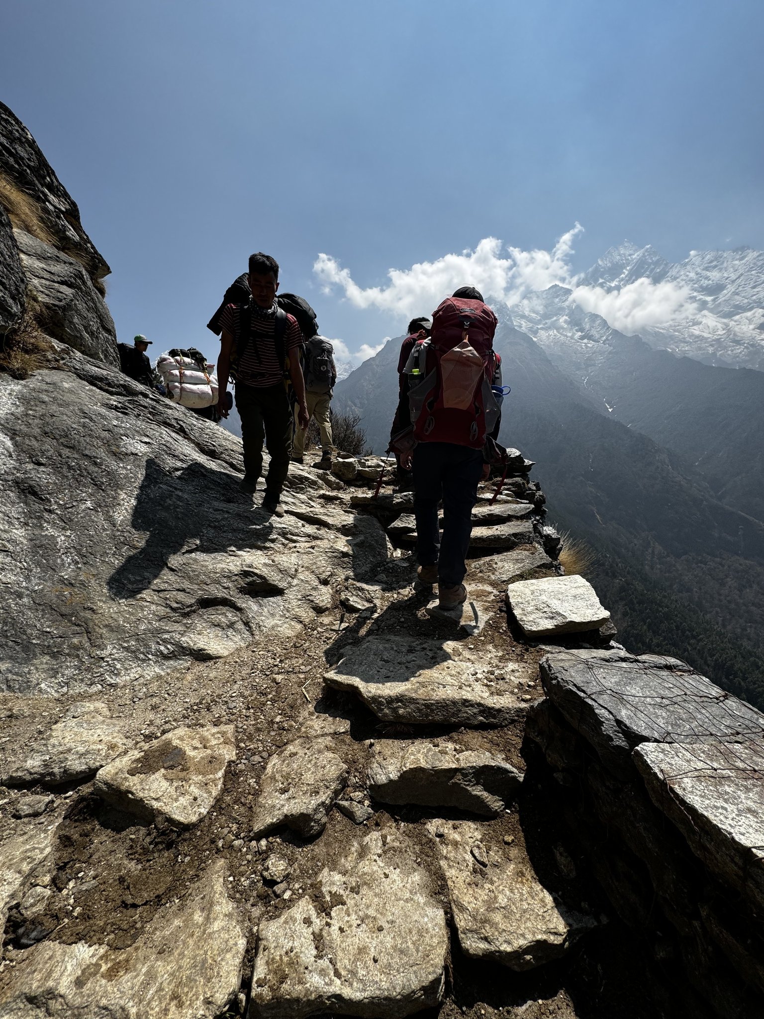 Trekkers hiking a mountain trail toward Everest Base Camp