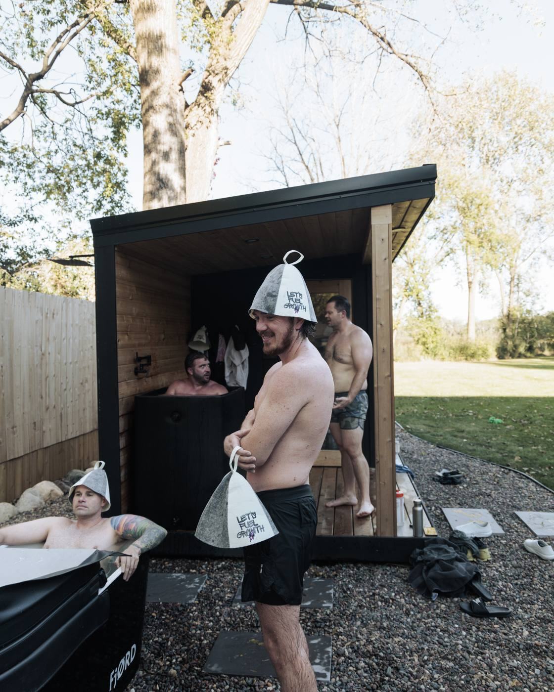A Let's Fuel Growth community group gathered around a cold plunge tub at a summit event