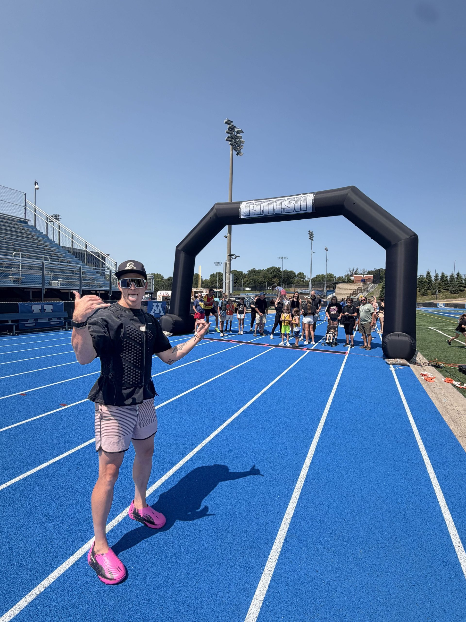 Runners and families crossing the finish line together at the MN Mile